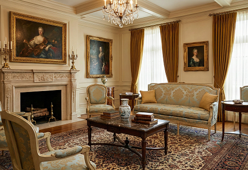 Classical living room with fireplace: sofa and armchairs in blue-gold upholstery, symmetry, and patterned rug