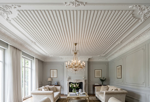 White slat panels for the ceiling combined with ceiling molding in a classic light interior