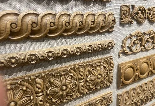 Various carved wooden moldings with floral and geometric patterns