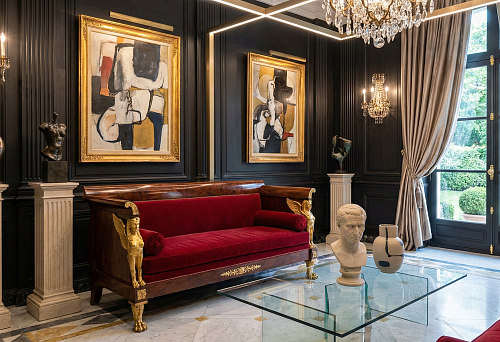 Empire style furniture: a velvet red sofa with gilded overlays in the formal living room