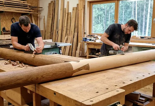 Round Wooden Handrail in Manufacturing Process: Sanding Long Solid Wood Blank for Stair Railings