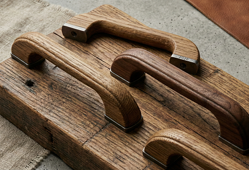Close-up of Wooden Furniture Handles with Matte Texture Against Rough Wood Background