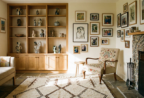 living area with wooden shelving and a ceramic collection