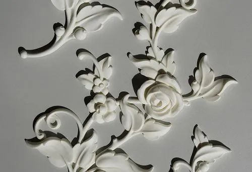 Stucco decoration on the ceiling &mdash; a set of white decorative elements made of polyurethane with floral-leaf ornament for architectural transformation of the ceiling.