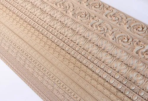 Set of carved wooden moldings and panels for wall decoration in a modern 2025 interior.