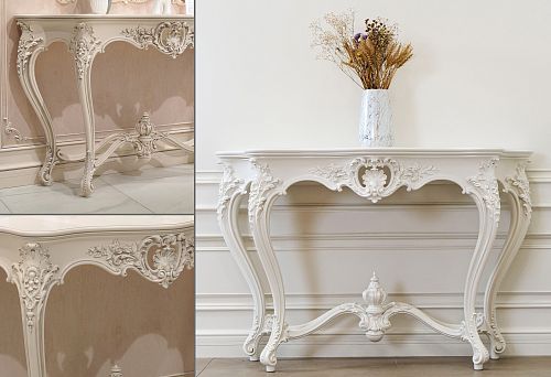 White carved console table with decorative elements and curved legs