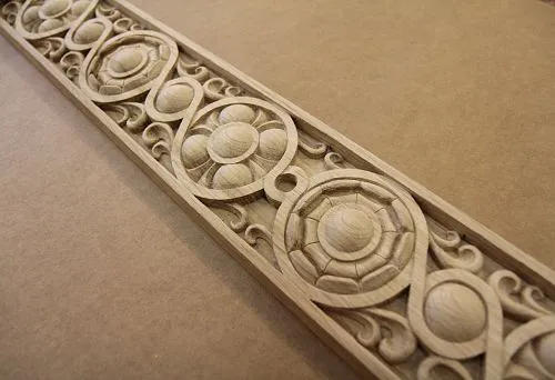 Fragment of carved wooden picture frame with geometric ornament