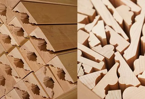 Set of shaped elements made of solid wood, neatly arranged for further furniture assembly.