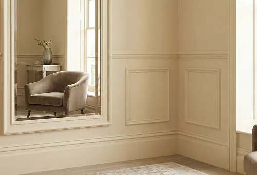 Harmonious interior in a unified style: light baseboards and wall moldings with classic panels