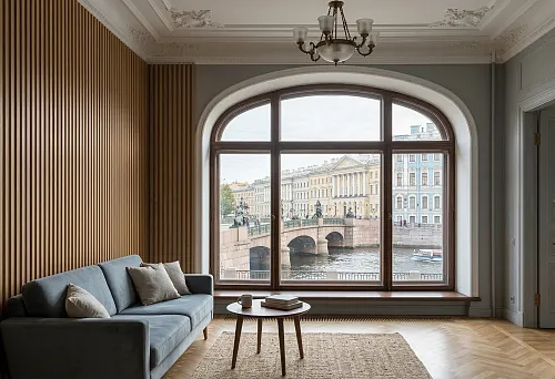 Slat wall panels in St. Petersburg in an interior with a large arched window and a view of the historic center