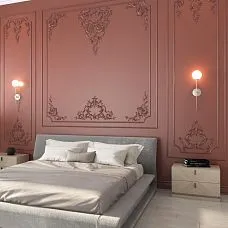 Bedroom with an accent wall made of STAVROS polyurethane moldings&mdash;frame decor in terracotta-pink tones with Baroque ornaments above the bed headboard