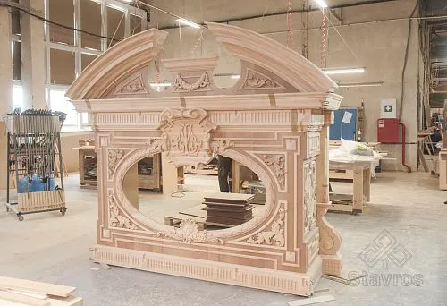 Ready-to-assemble carved fireplace area in classic style in workshop