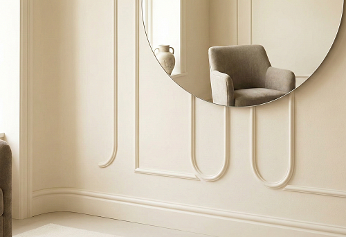 Light interior with paneled walls: large round mirror on the wall, oval moldings in the form of elongated arches