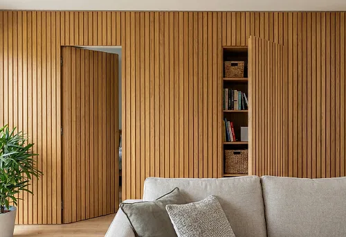 Wooden slat wall with hidden door and niche cabinet: slats conceal storage in the living room