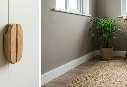 Wooden furniture handle on a light facade and white MDF skirting in apartment interior &mdash; eco-accents in budget renovation
