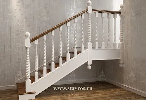 White wooden balusters with spiral carving, installed on a staircase in the interior