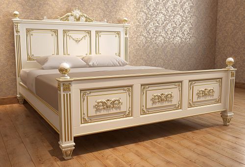 Elegant bed made of natural wood with carved decoration and gold trim against a classic interior