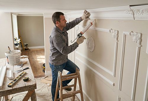 Installing plasterwork on the wall yourself: a master installs decorative moldings and plaster decor on the wall