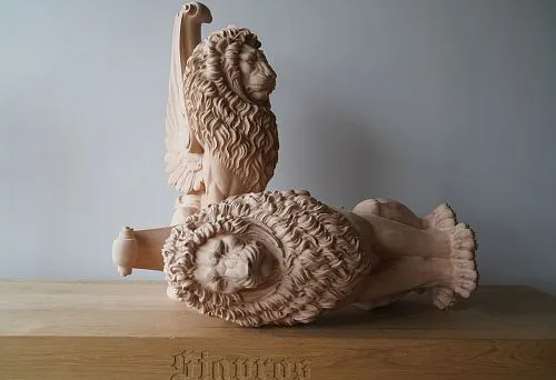 Carved oak lion figures &mdash; handcrafted with deep relief in manes and anatomical precision