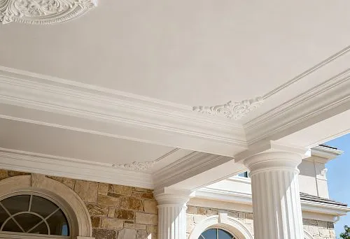 Ceiling molding and facade decor of a classic house with columns and arched windows