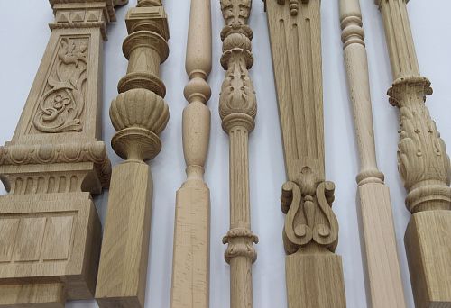 Set of carved wooden balusters in Roman and classical styles on a white background