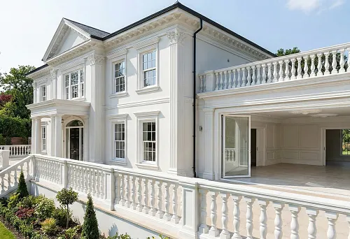 Polyurethane stucco molding for house facades and balusters: classic exterior with balustrade and columns