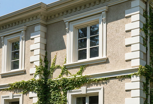 Polyurethane facade stucco molding on a house: cornices, architraves, and rustications as wall protection and decoration
