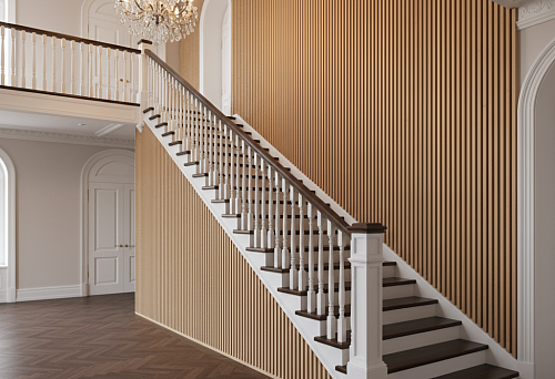 An interior with a staircase and wooden balusters that harmonize with the vertical wall finish creates an expressive architectural rhythm in the space