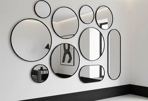 Composition of round mirrors in black thin frames on a white wall and a straight dark baseboard along the perimeter