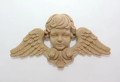 Close-up of an angel carved from wood with wings.
