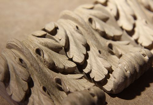 Fragment of carved oak ornament with large leaf elements, handcrafted.