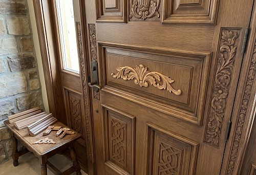Wooden door decor with carved overlays