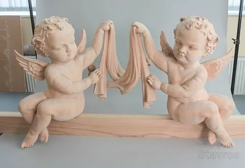 Close-up of carved wooden angels.