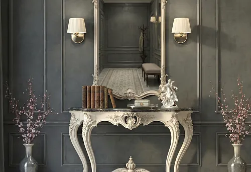 Versailles console with carving and tall mirror in hallway against gray walls