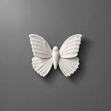 NPU-481 molding in the form of a white butterfly on a gray background.