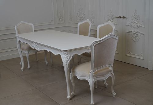 Carved leg decor for wooden table with delicate patterns.