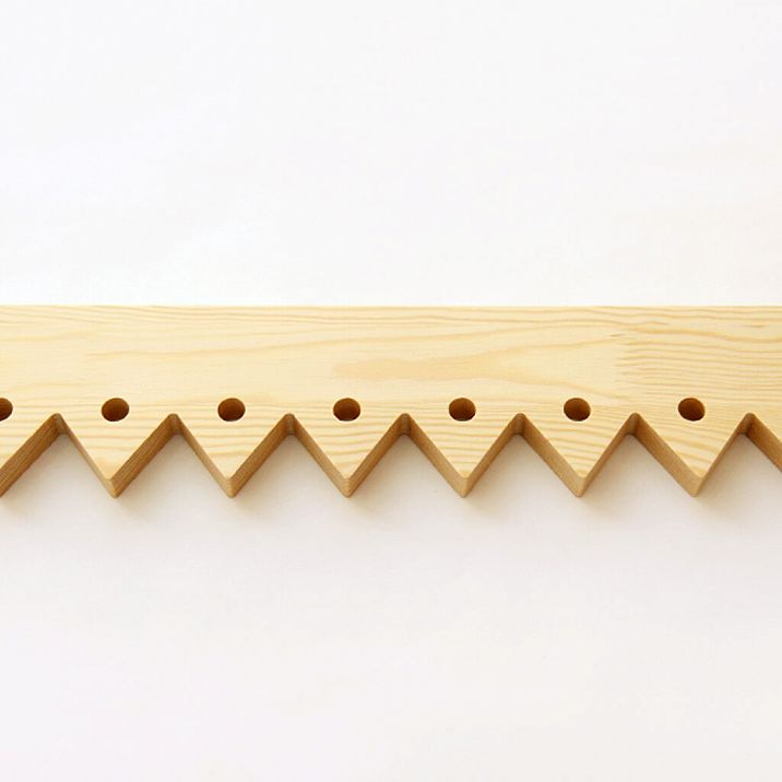 Facade of a wooden house with carved door stops NL-5