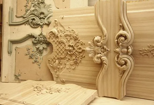 Carved wooden elements for furniture design, including intricate patterns and decorative panels.