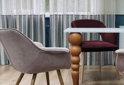 Minimalist interior with a dining table on round wooden legs.