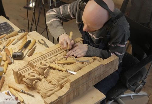 The Master Carves a Complex Relief Ornament by Hand from Solid Natural Wood