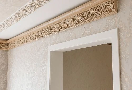 Decorative strips on the wall and ceiling with carved ornament