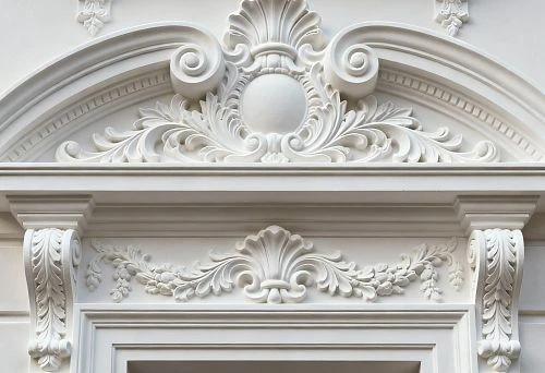 Facade stucco with decorative elements above the window in classic style