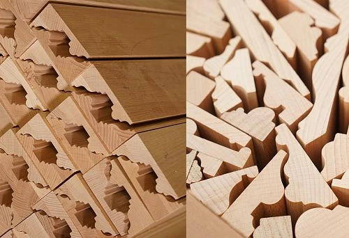 Set of shaped elements made of solid wood, neatly arranged for further furniture assembly.