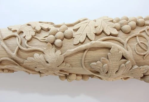 Complex carved detail from solid oak with grape leaves and clusters