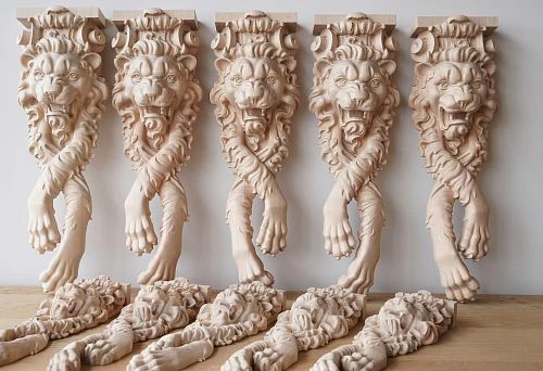 Carved wooden elements with lion motifs, executed in the classical style.