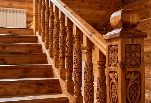 Carved wooden staircase with decorative balusters and ornamental posts in Russian style