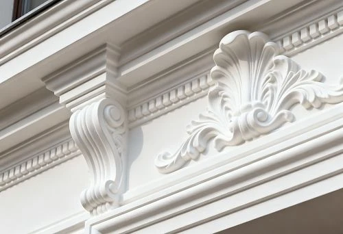 Facade cornice decor with stucco elements above the window in classic style
