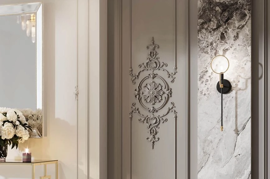 Brussels stucco medallion on a wall panel next to a marble insert and a wall sconce