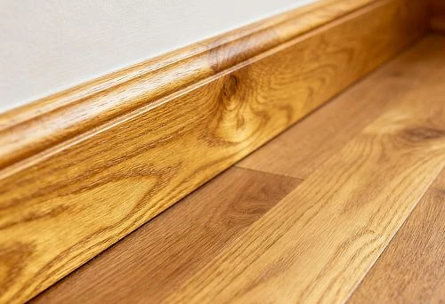 Close-up of solid oak wooden baseboard for floor