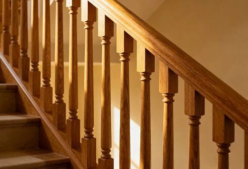 Wooden balusters on a staircase with proper geometry and precise attachment